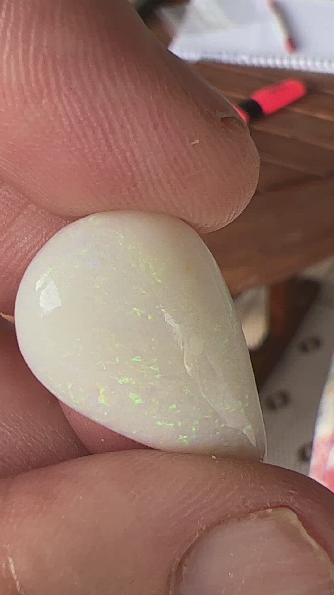 Large teardrop shaped solid white opal from Coober Pedy, featuring striking pinfire greens. Ready for a pendant. An excellent bargain.