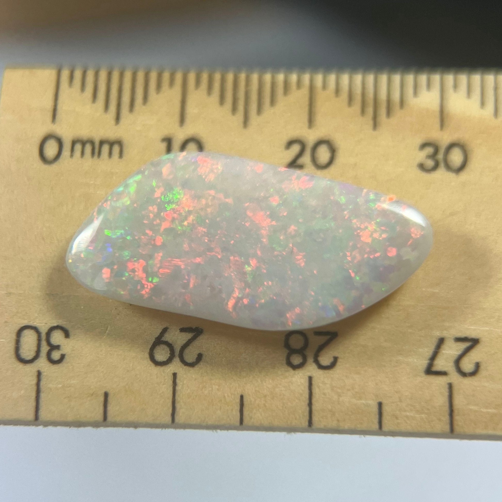 Lightning Ridge solid opal. Well shaped stone displaying stunning colours from all angles including plenty of reds, orange and greens.