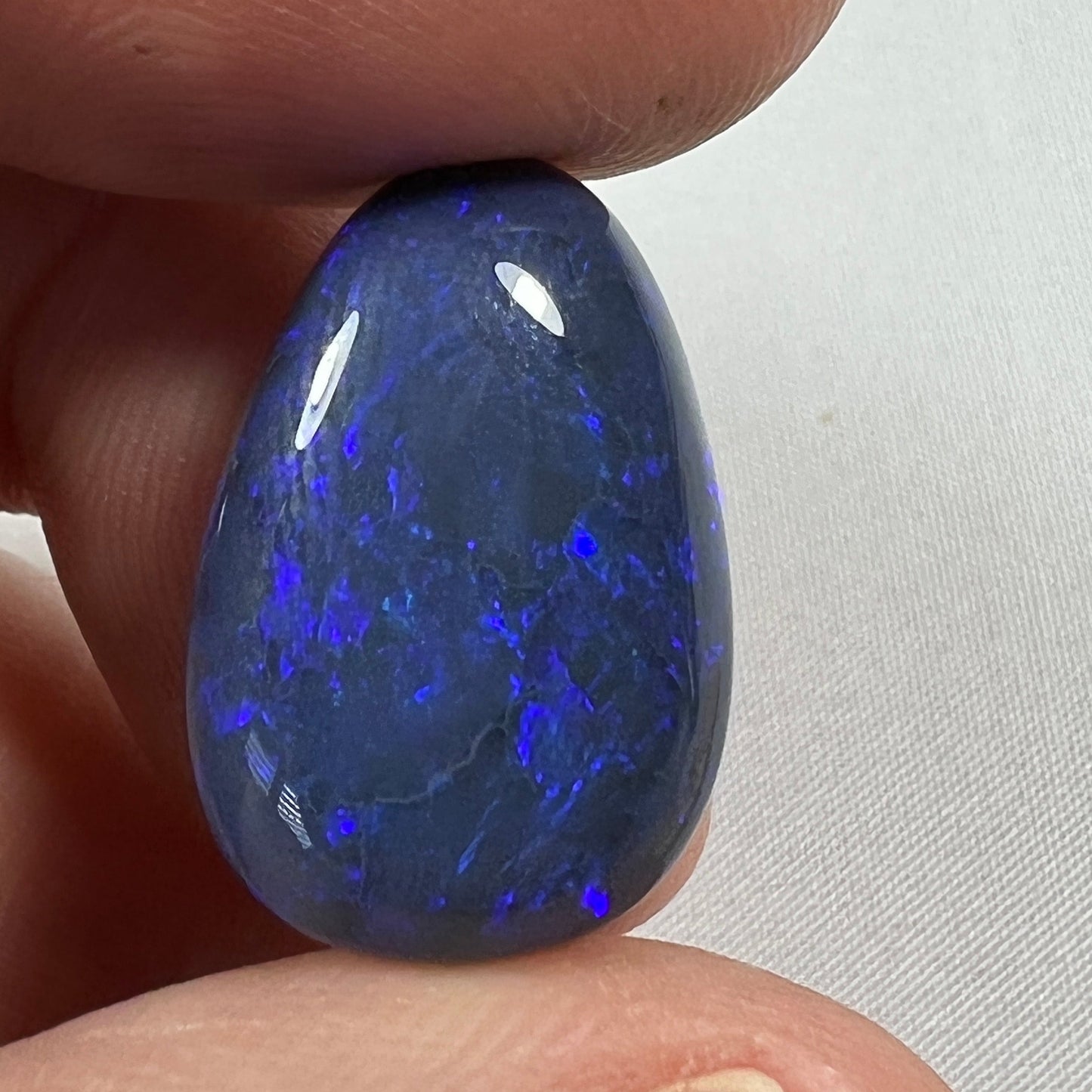 'Blue on black' solid black opal from Lightning Ridge. Perfect quality with awesome deep blue colour. This stone originated in the rough from the Tunnel Rats and was supplied to us from Phoenix Gems.