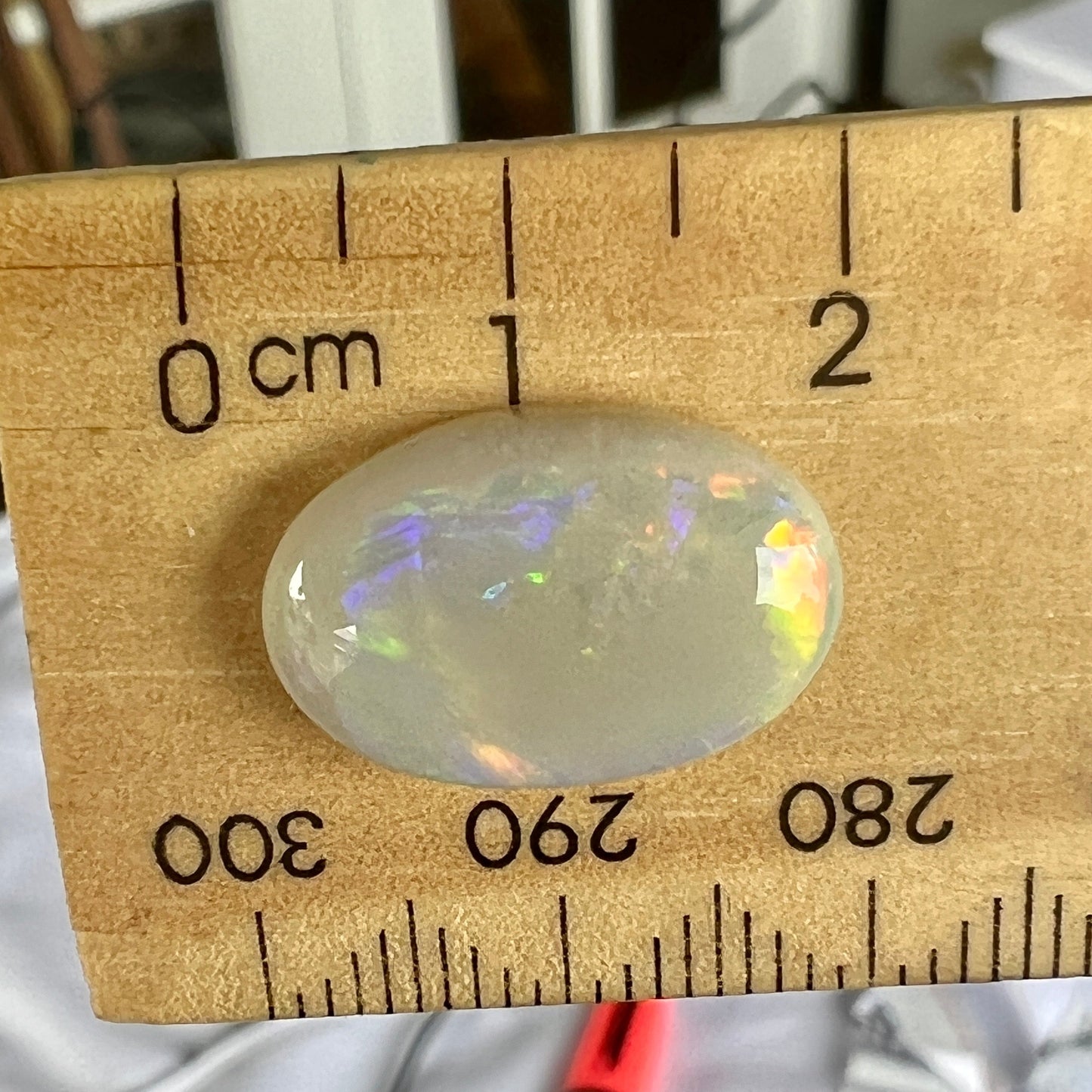 Beautiful rare Mintabie oval solid opal, displaying magnificent purple, blue, green and orange. Ready to set.