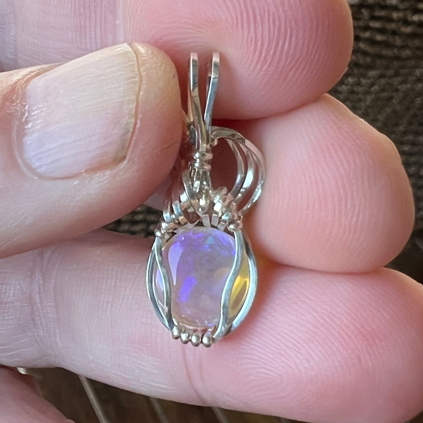 Beautifully cut Lightning Ridge Jelly Crystal opal. Cut and polished by Bill Johnson. Expertly set in a unique silver wire wrap. An awesome hand made gift.