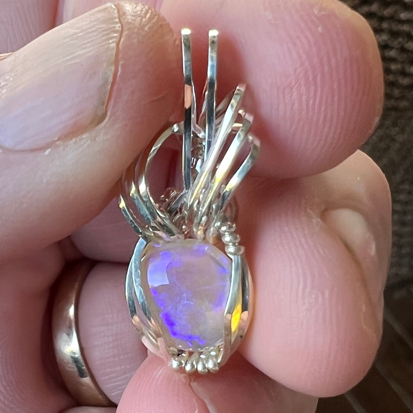 Beautifully cut Lightning Ridge Jelly Crystal opal. Cut and polished by Bill Johnson. Expertly set in a unique silver wire wrap. An awesome hand made gift.