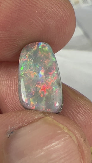 The colours in this opal are a knockout. Bright reds, blues, and greens. A dark opal from Mintabie. Ready for setting.