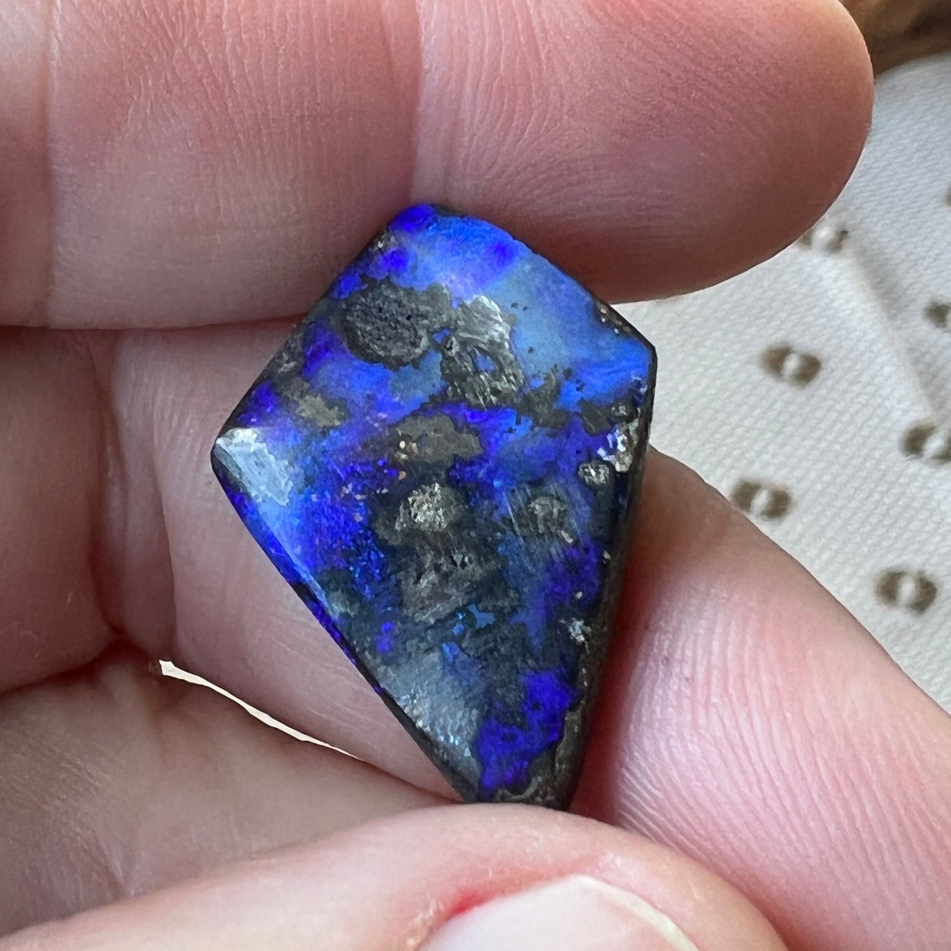 An unusual shaped piece of Winton boulder opal, showing beautiful blues.