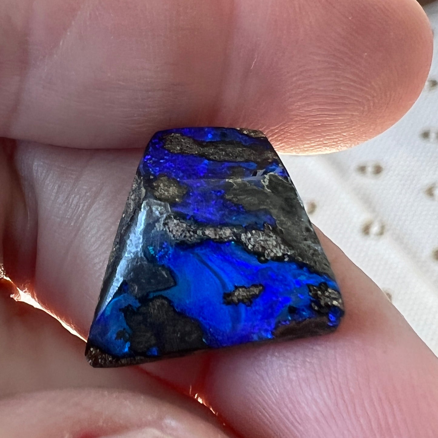 An unusual shaped piece of boulder opal with stunning blues throughout. 