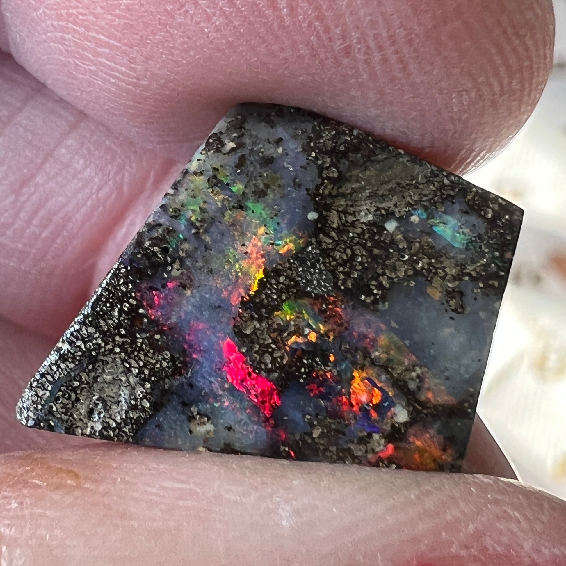 Nice play of colour in this lovely boulder opal, including vibrant reds.