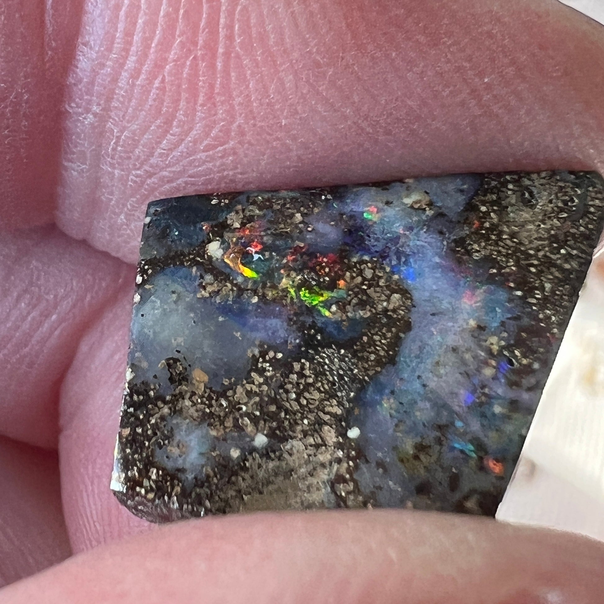 Nice play of colour in this lovely boulder opal, including vibrant reds.