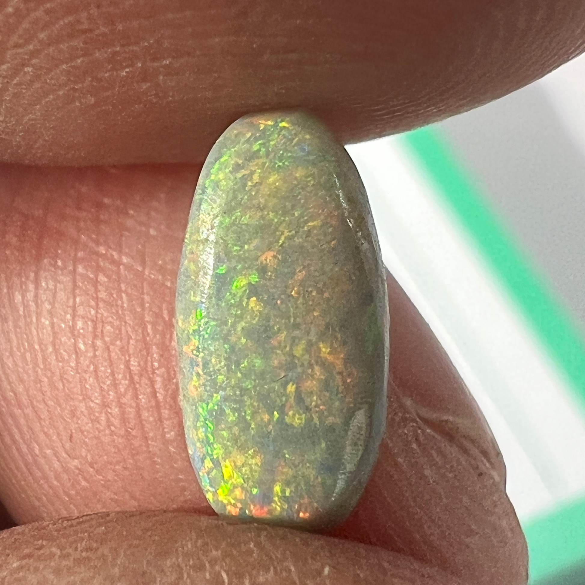 A cracker of a gemstone from Lightning Ridge. Grey and multi-coloured. Ready to set.